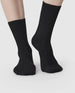 Swedish Stockings Bodil chunky knit wool socks shown worn on a model's foot from the calf down while they face forward. 2