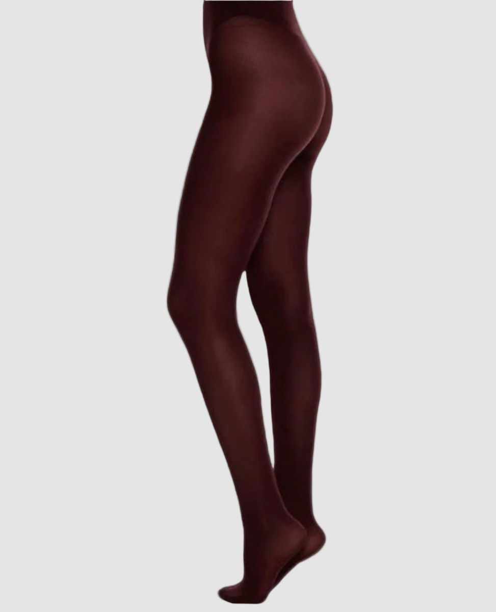 Opaque, burgundy-colored tights with a smooth, form-fitting texture, extending from the waist to the toes, made of a stretchy, nylon-blend material.