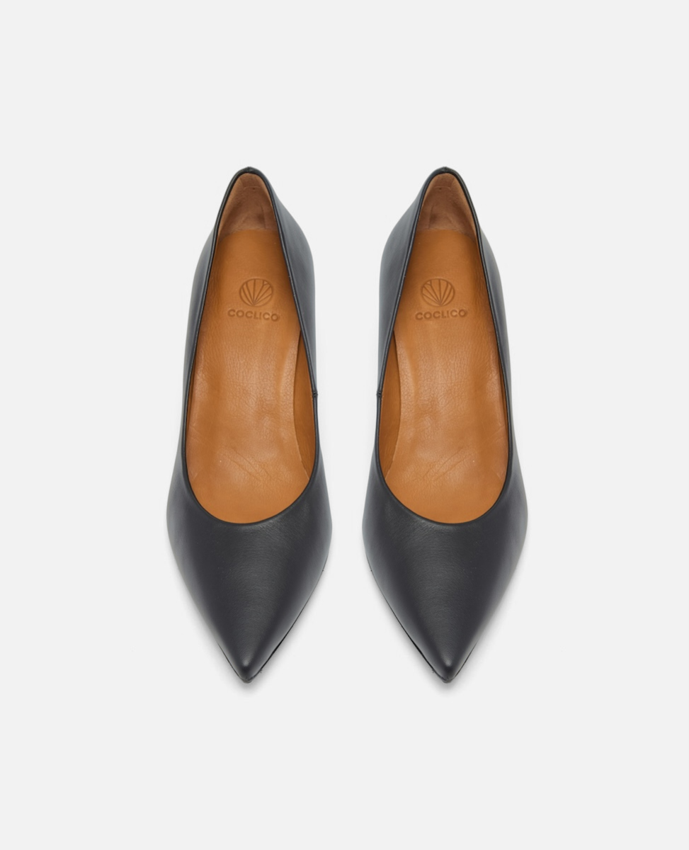 Pair of black pointed-toe shoes with tan insoles on a white background