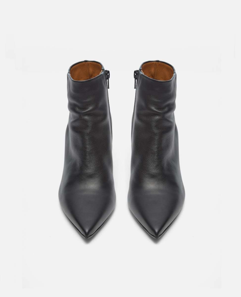 Pair of black leather ankle boots on a white background