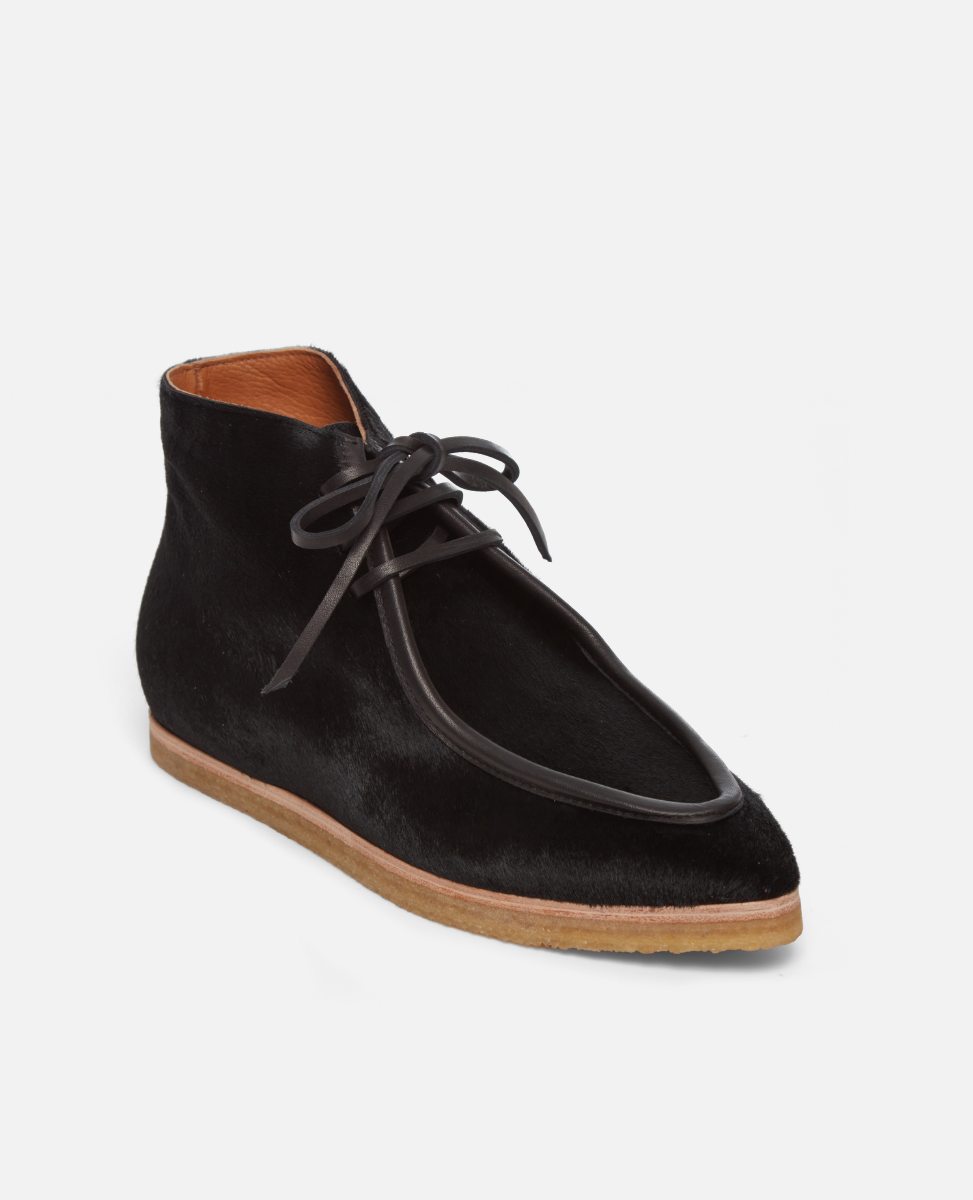 Black haircalf lace up shoe with crepe sole on a white background