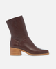 Brown leather ankle boot with a block heel on a white background 1
