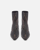 Pair of black pointed-toe boots on a white background 2
