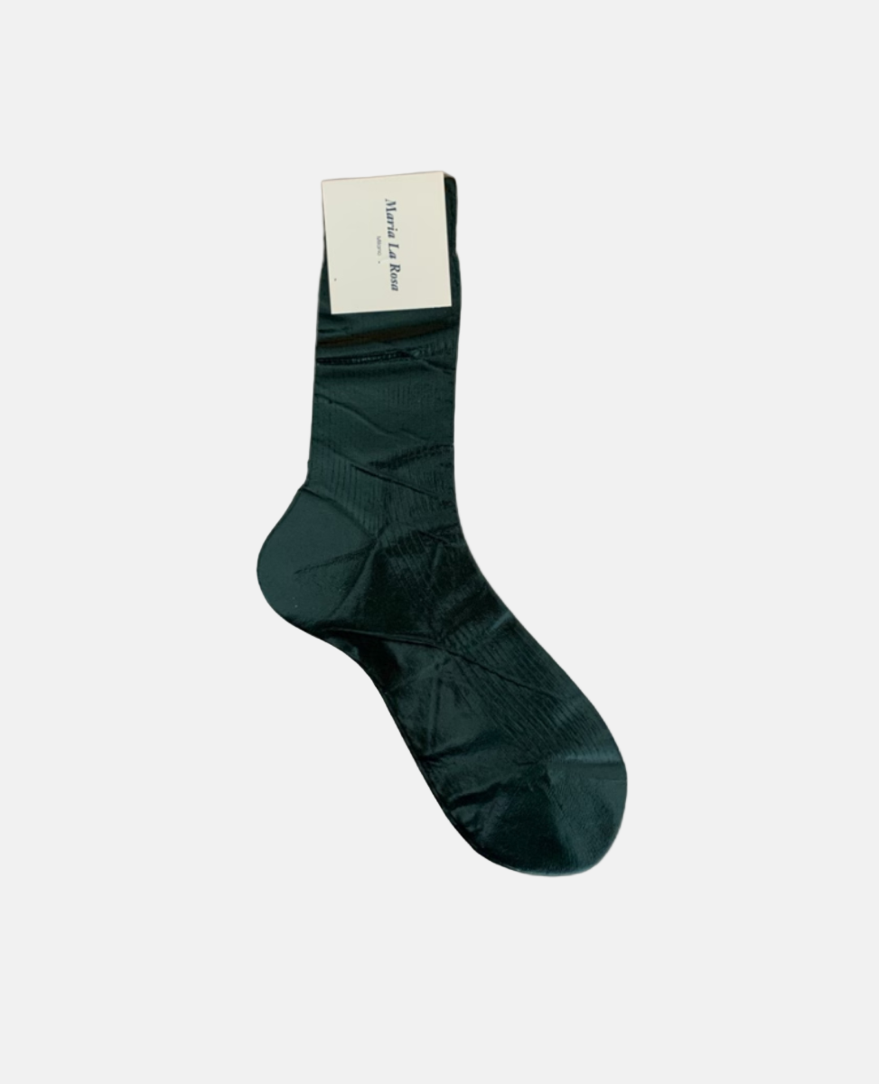 A single, dark green sock with a subtle geometric pattern, mid-calf length, made of a smooth, likely synthetic material, featuring a white label attached near the top.