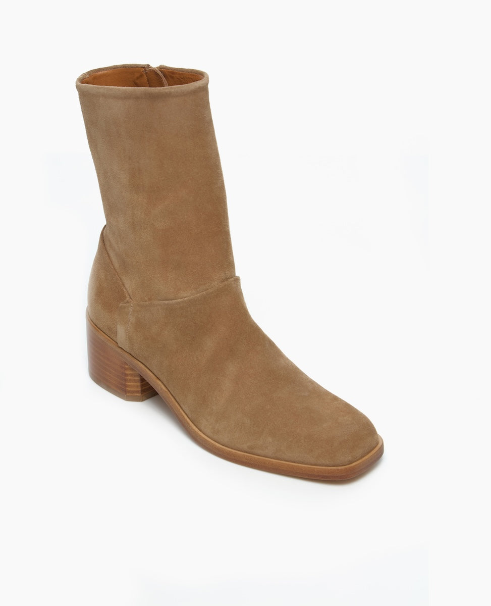A mid-calf, tan suede boot with a smooth texture, featuring a square toe, a side zipper, and a chunky stacked heel.