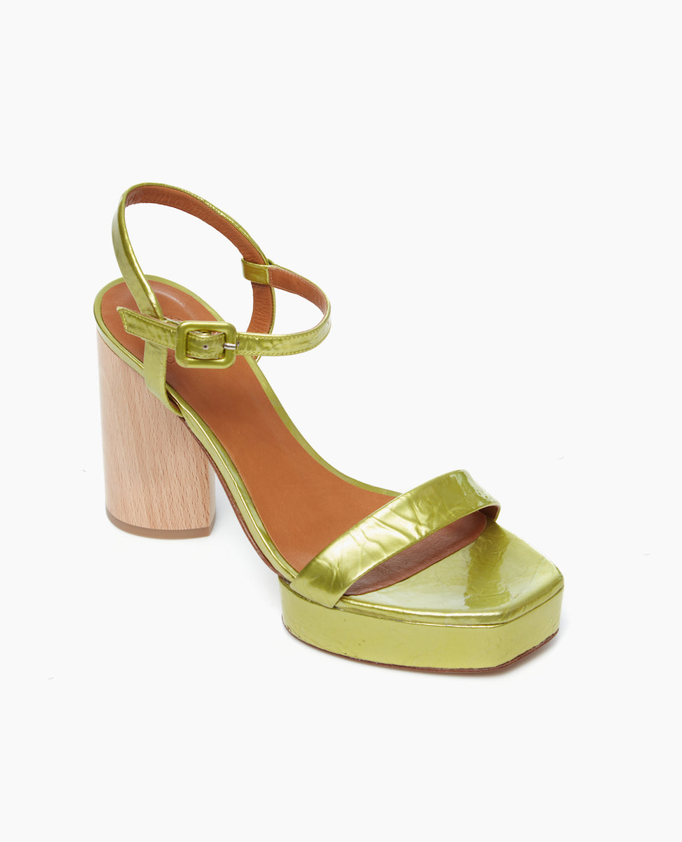 Angled view of the Angel Platform in chartreause patent leather. The heel is carved from solid ash wood, while the platform is made from lightweight, leather-covered, recycled cork.