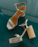 Side and top view of the Angel Heel in Grey Antiqued Patent against a teal backdrop. 7