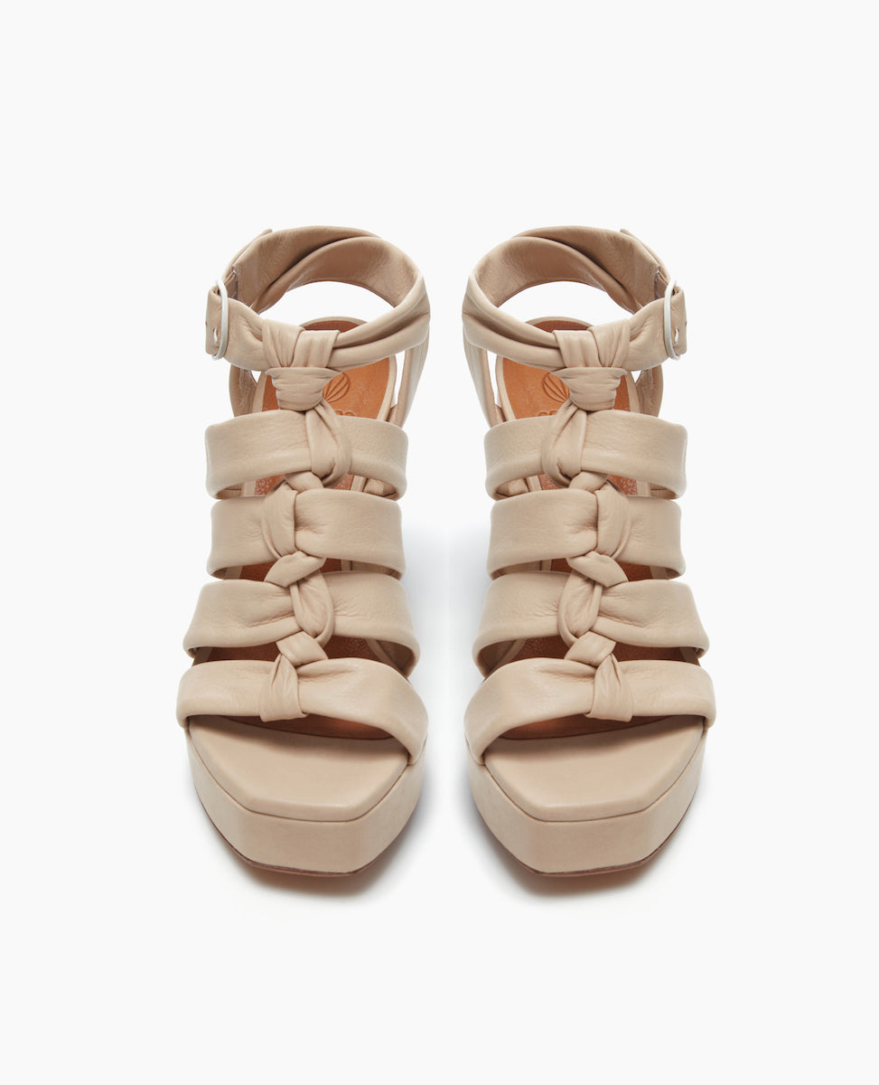 Front view of the April Heel in Latte Macchiato with a platform made from lightweight, leather-covered, recycled work.