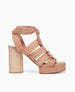 Side view of the April Heel in Fawn leather with straps twisting and securing at the ankle by a buckle fastening.  1