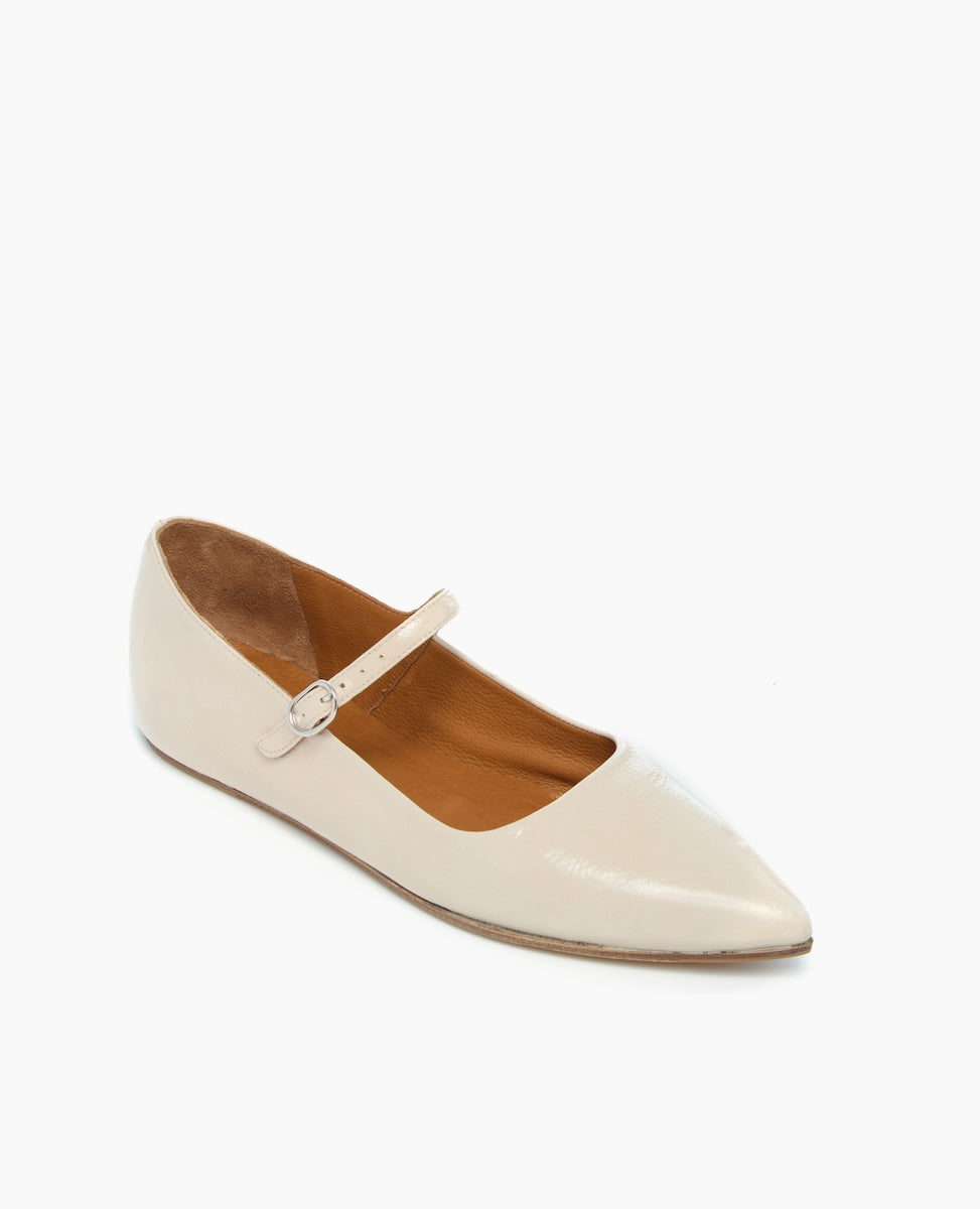 A sleek, beige, pointed-toe flat shoe with a smooth leather texture, featuring a thin strap with a small buckle across the top.