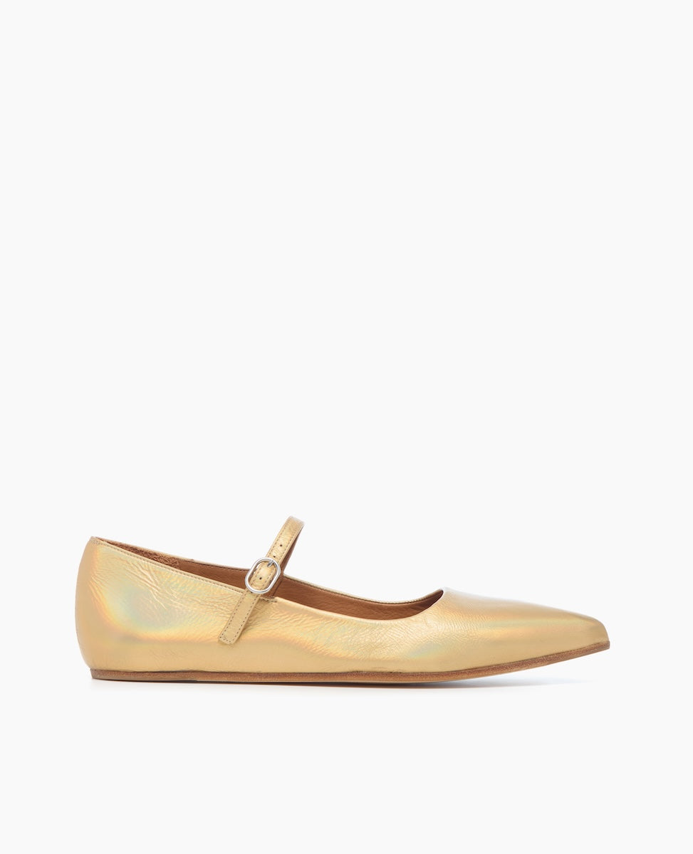A sleek, gold-colored flat shoe with a pointed toe, featuring a smooth, shiny texture and a thin strap with a small buckle across the top.