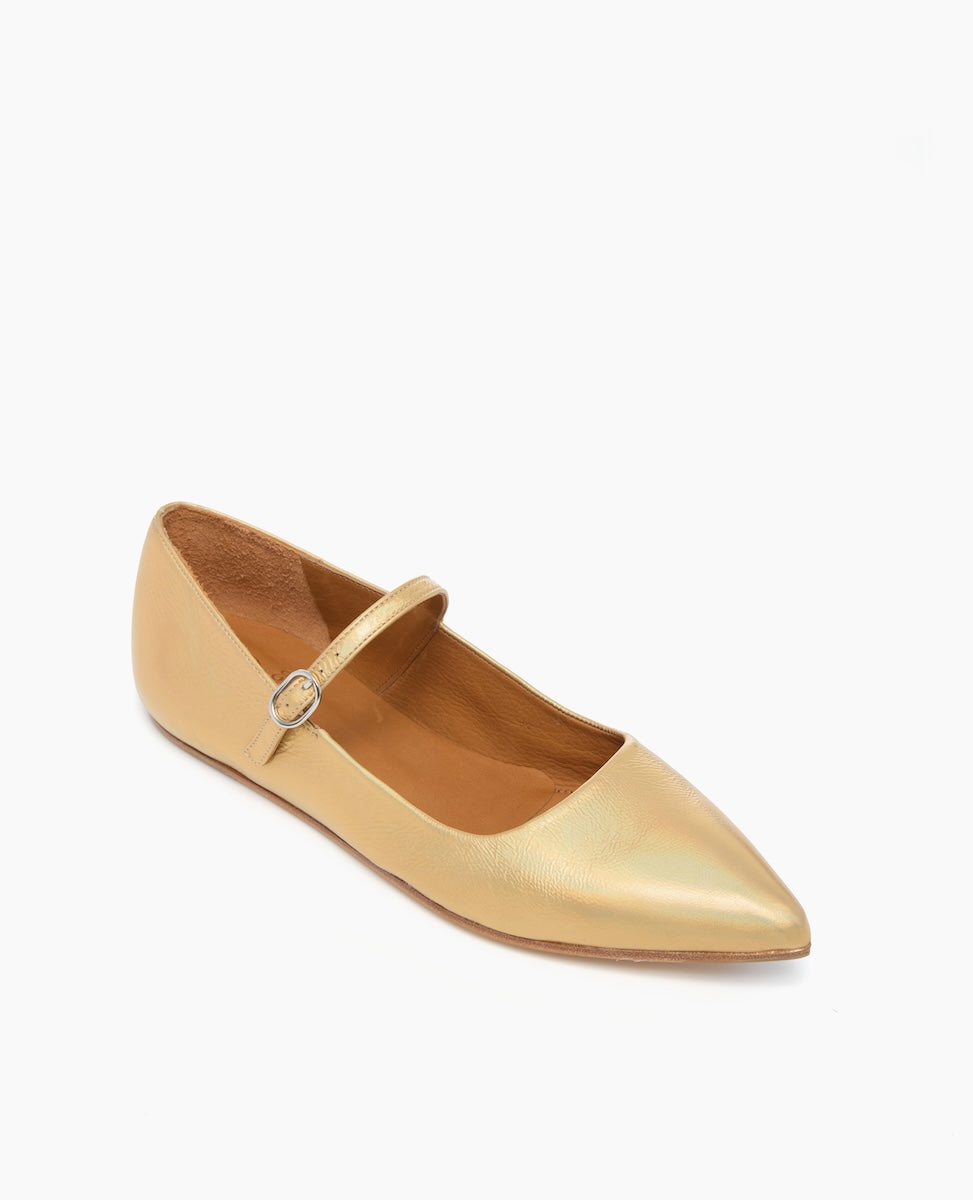 A sleek, pointed-toe flat shoe in a metallic gold color with a smooth leather texture, featuring a thin strap with a small buckle across the top.