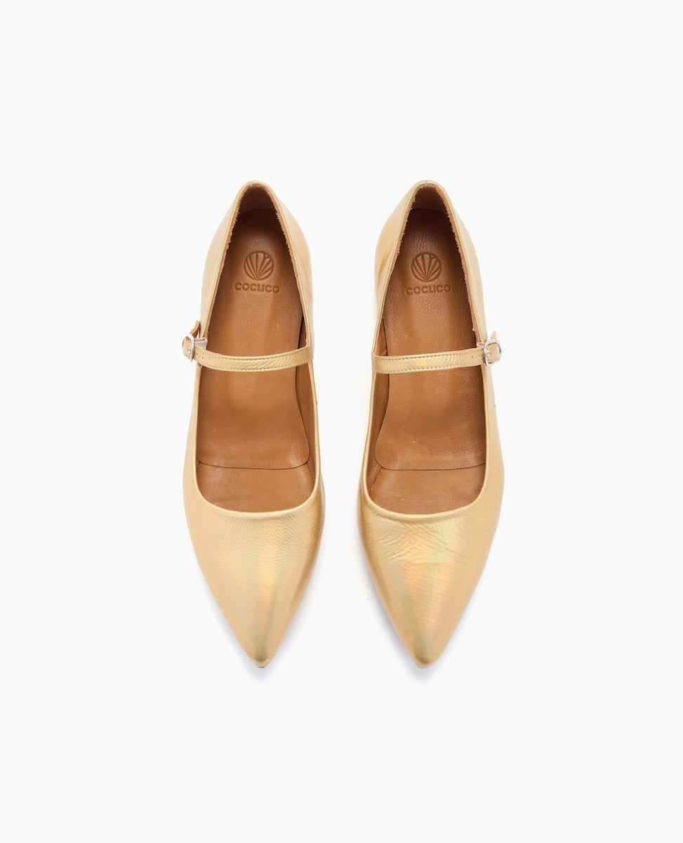 A pair of elegant, pointed-toe, gold-colored Mary Jane shoes with a smooth, shiny texture, featuring a single strap with a small buckle across the top.