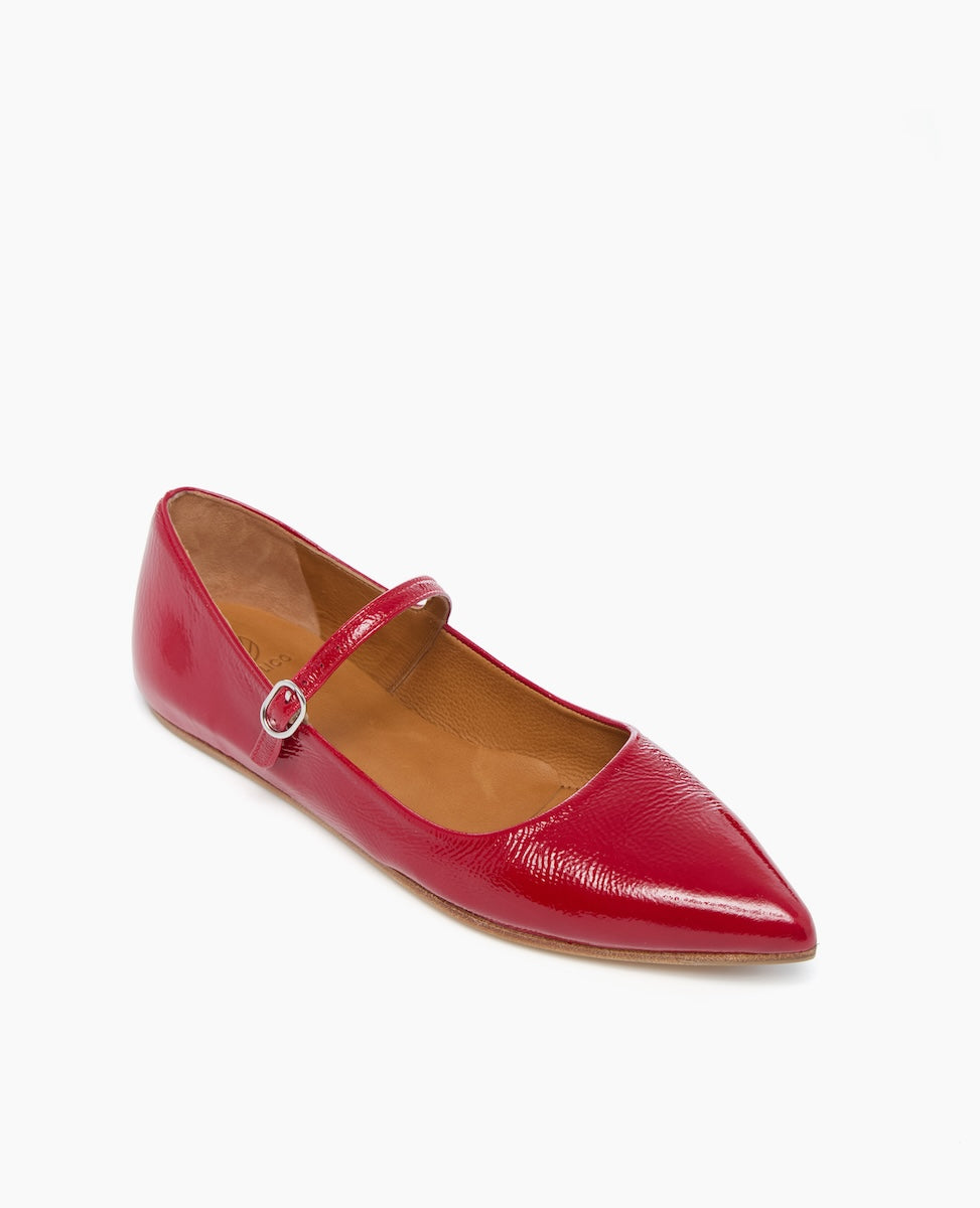 A sleek, red, pointed-toe flat shoe with a glossy finish, featuring a single thin strap with a small buckle across the instep, and a smooth tan interior.