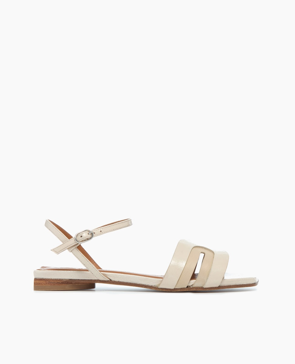 side view of White Sandals with arched strap and buckle closure