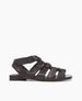 Side view of the Flair Gladiator Sandal in Black featuring the softest, tubular leather straps that twist upward and are secured at the ankle by a buckle fastening. 1