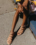 Legs and feet wearing the Flair Sandal in Fawn.  2