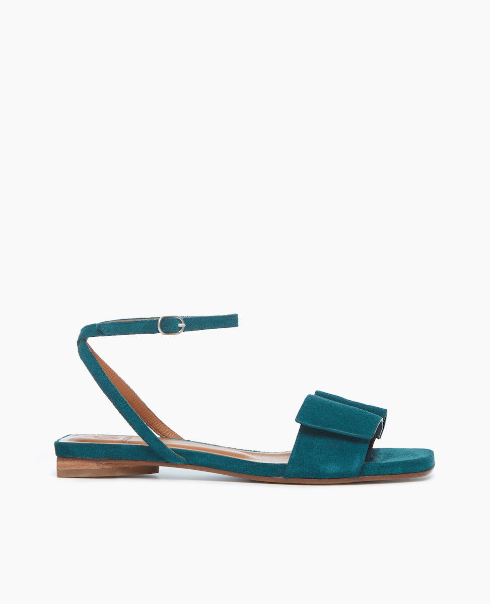 Side view of the Frances Sandal in Azure with an architectural loop and fastened at the ankle with a slim strap and buckle closure.