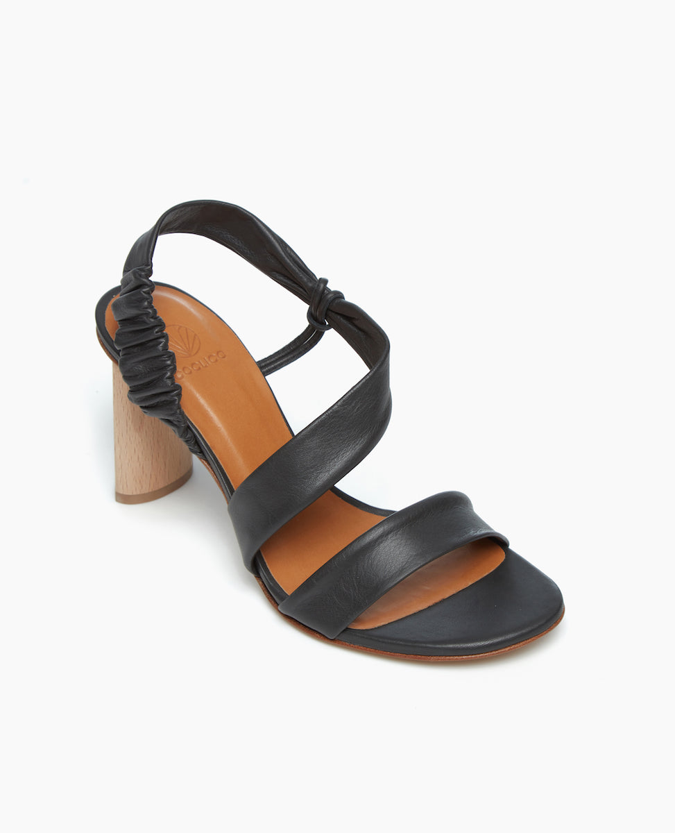 Angled view of the Gabby Heel in Deep Sea, with a sculpted heel from solid Ash wood with internal steel reinforcement.