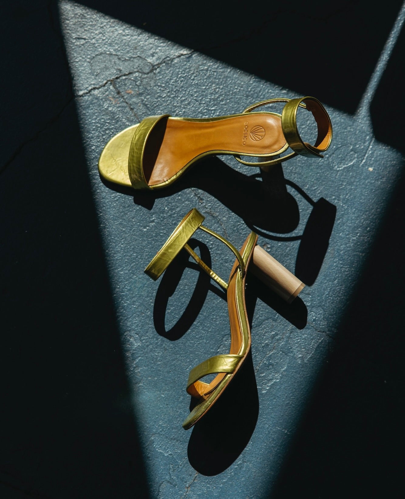 Above view of the Gina Heel in Chartreause Antiqued Patent against a blue concrete floor.