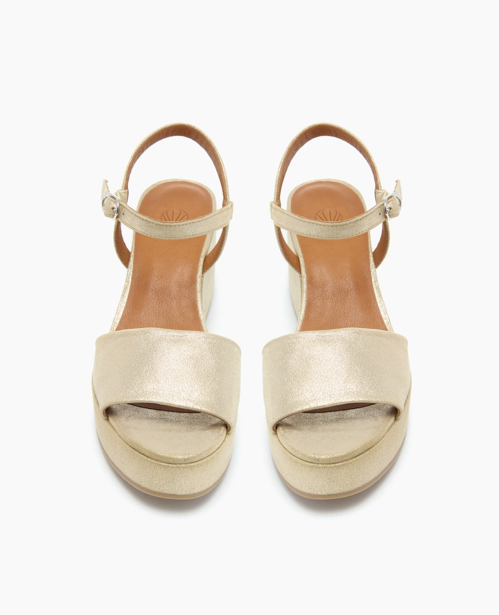 Top view of the Lauren Wedge in Champagne Shimmer Suede with an upper that sits atop a solid inset wedge and straps at the ankle.