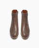 Front view of the Nigella Clog in Taupe Leather. Set on a solid wood heel and platform, the midsole is rounded and completely unique, with a simple, clean bootie silhoute. Side tab. Inside-zip closure. 3