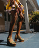 Legs of a woman outside standing with feet apart and wearing the Obion Clog in Mosstone. 2