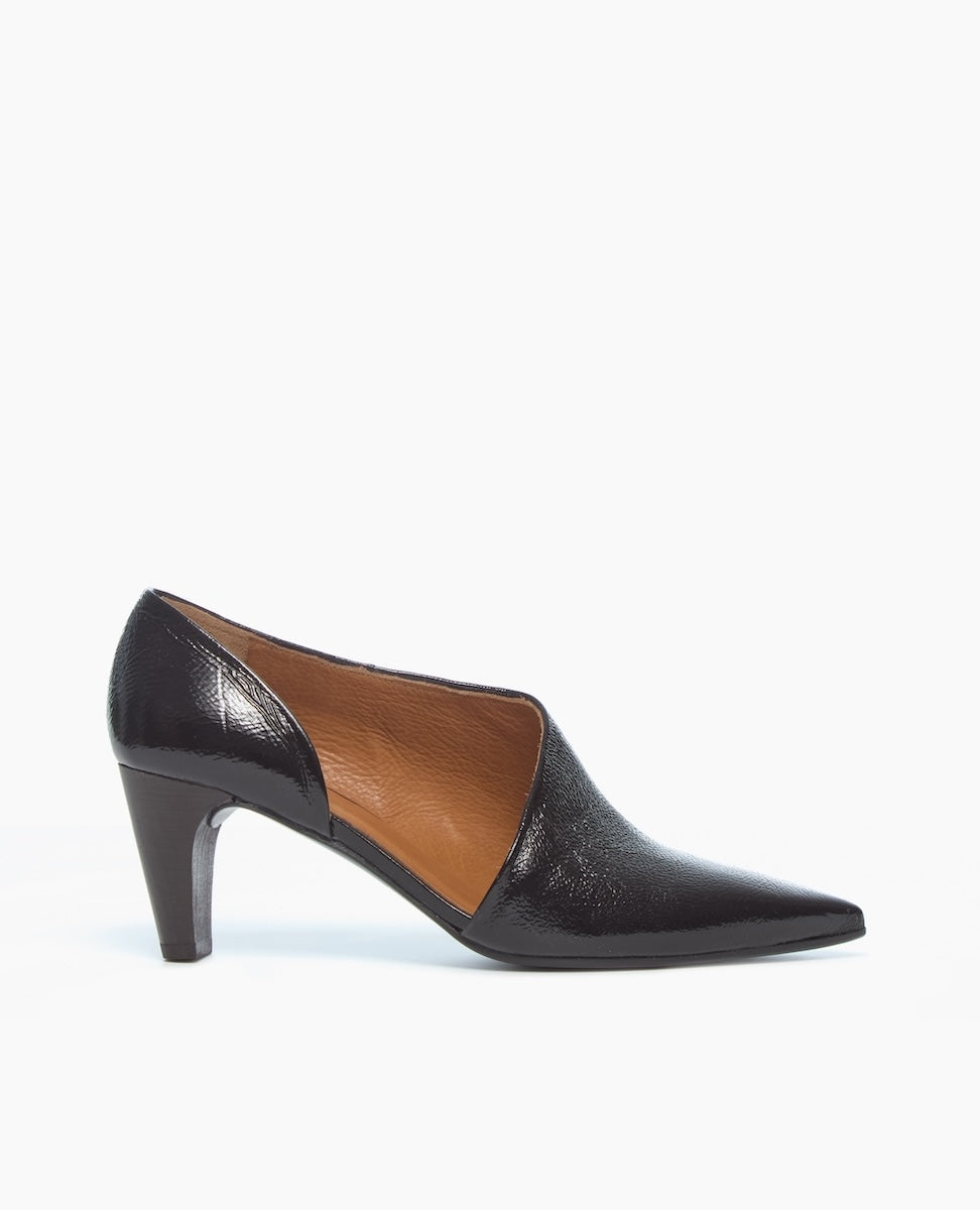 A sleek, black, pointed-toe high heel shoe with a glossy finish, featuring a cut-out design on the sides and a medium-height stiletto heel.