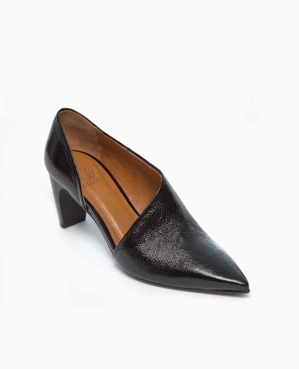A sleek, black leather high-heeled shoe with a pointed toe, a smooth, glossy finish, a tan interior, and a chunky, angular heel.
