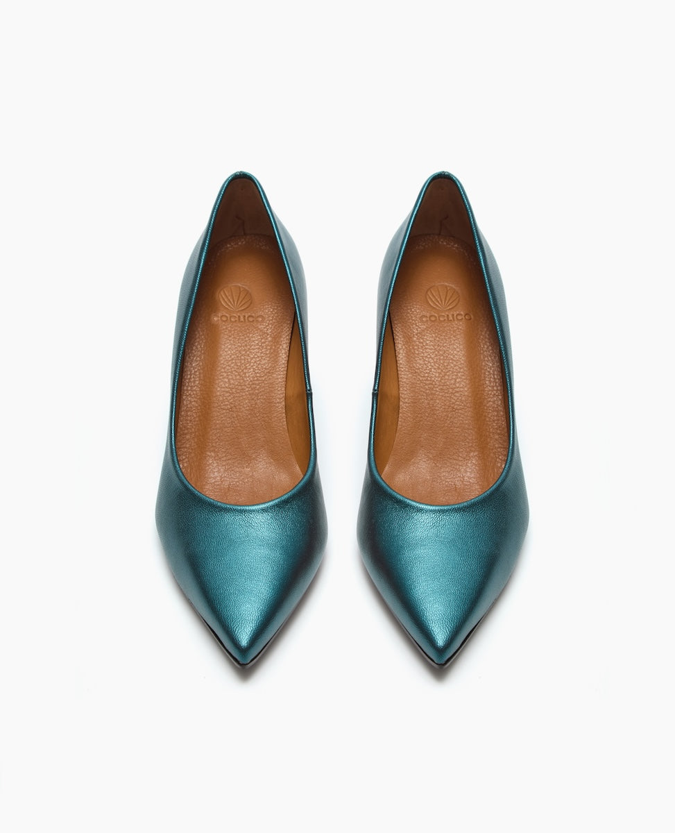 A pair of metallic teal, pointed-toe high heels with a smooth, glossy finish and tan leather insoles.