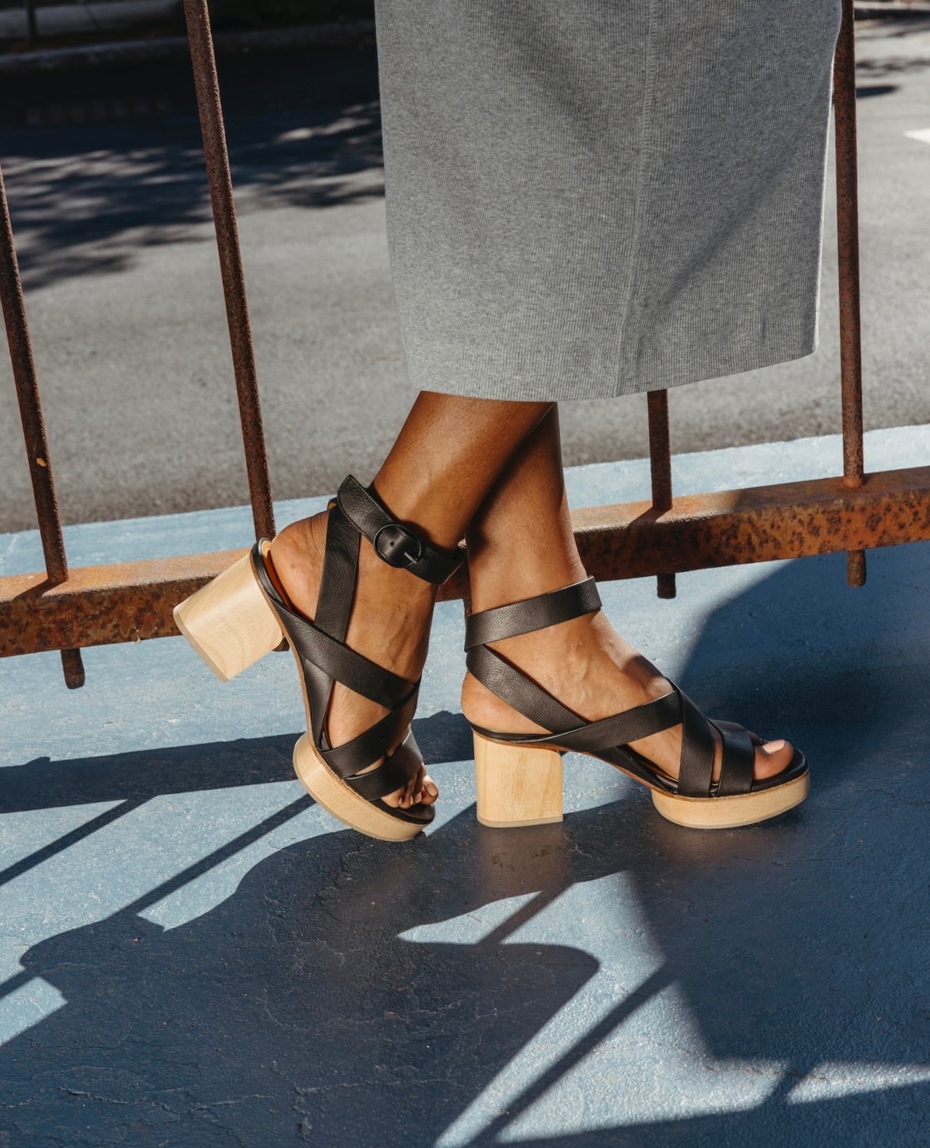 Side view of a woman's feet wearing the Roli Clog in Black.