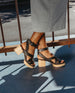 Side view of a woman's feet wearing the Roli Clog in Black. 5