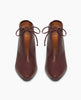 Front view of the Waffles Bootie in Merlot Leather; featuring a softly arched solid wood heel and gathered tie at the ankle revealing just enough to be both feminine and practical. 3
