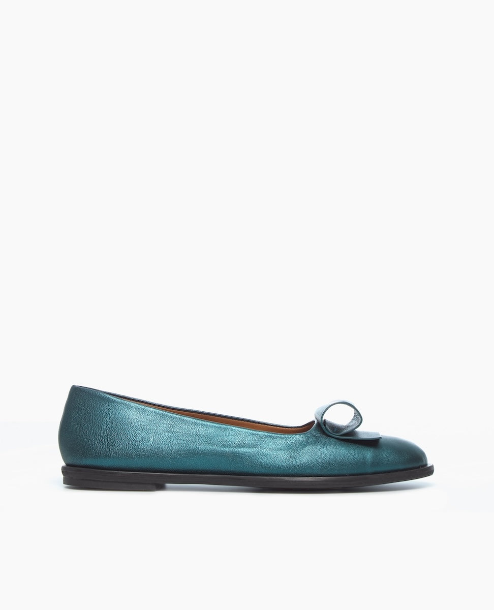 A teal-colored, flat ballet shoe with a smooth, glossy texture, a rounded toe, an architectural loop detail, and a thin black sole.