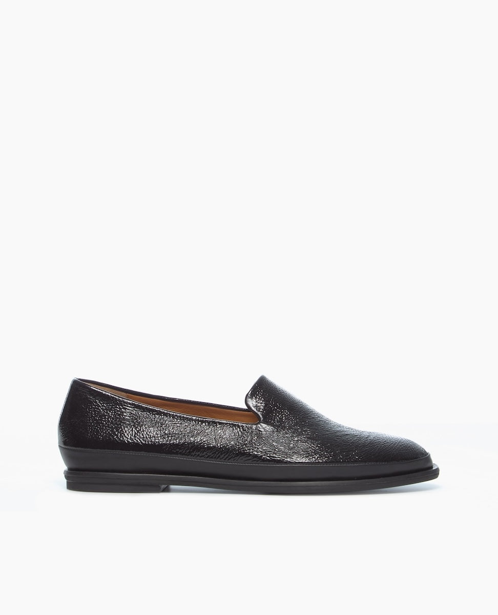 A sleek, black leather loafer with a smooth, glossy finish, featuring a low heel and a simple, slip-on design.