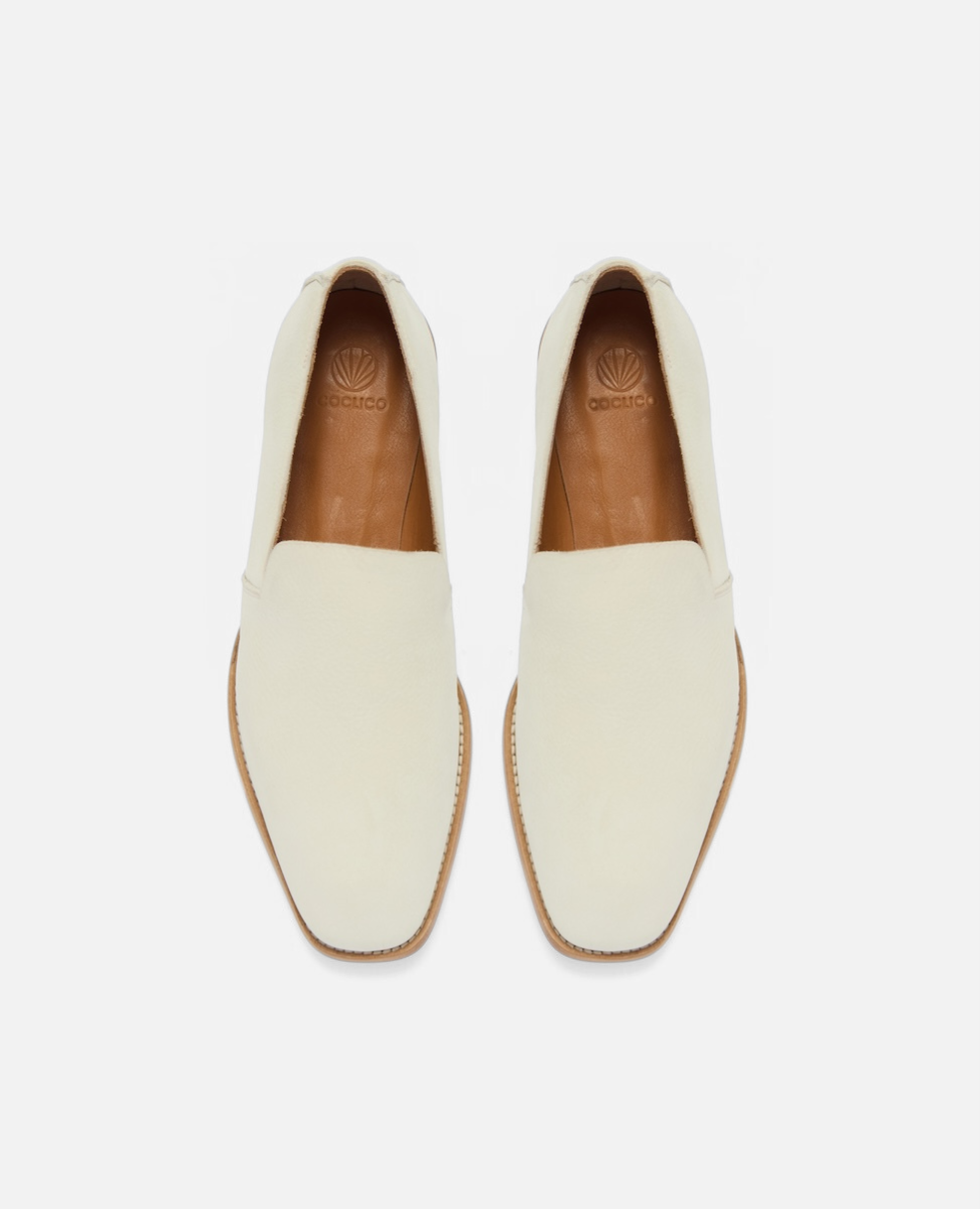Top view of a white nubuck leather slip-on loafer with a tapered square toe and low stacked heel on a white background
