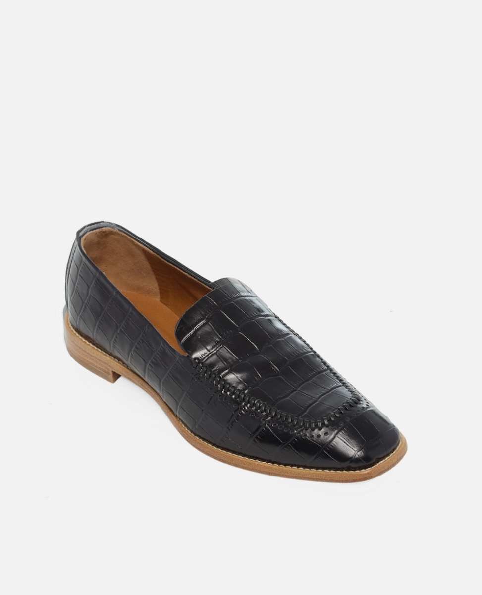 Angled view of a black croc-embossed leather loafer with a softly squared toe and low stacked heel on a white background