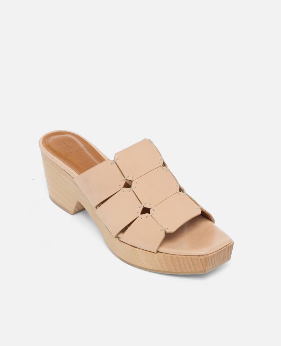 Angled view of a clog sandal in natural leather featuring linked straps, wooden heel, and open toe slip-on design