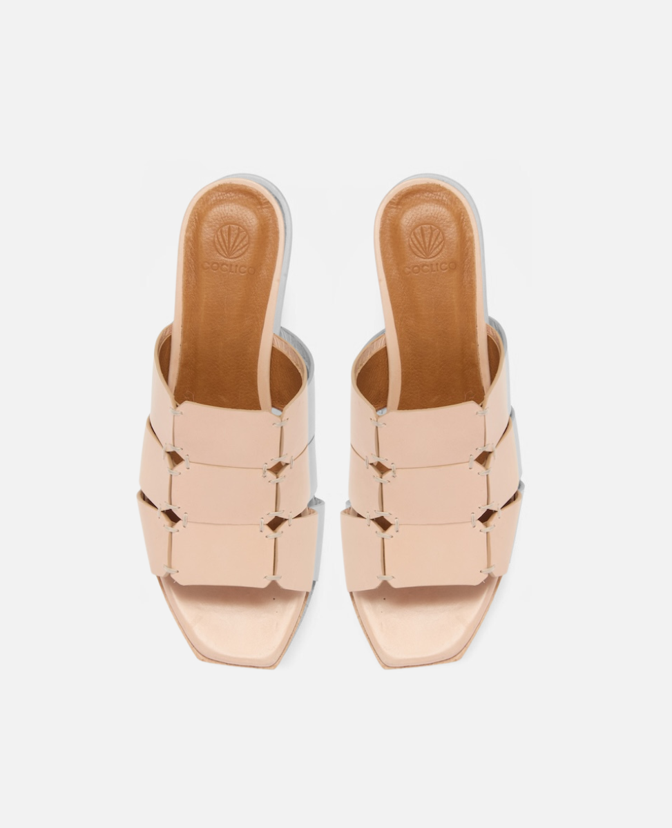 Top view of a clog sandal in natural leather featuring linked straps, wooden heel, and open toe slip-on design