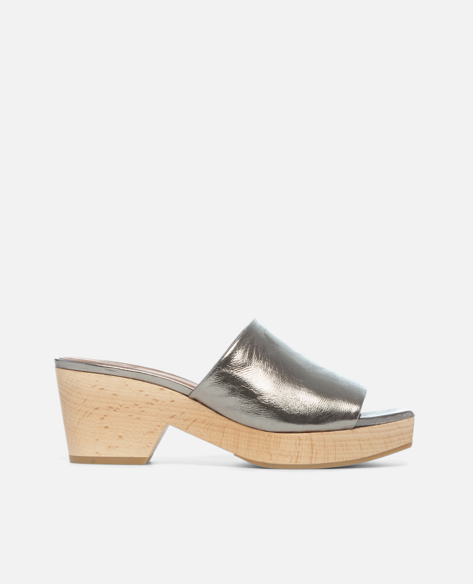 A metallic silver open-toe mule with a smooth leather upper and a light wooden block heel.