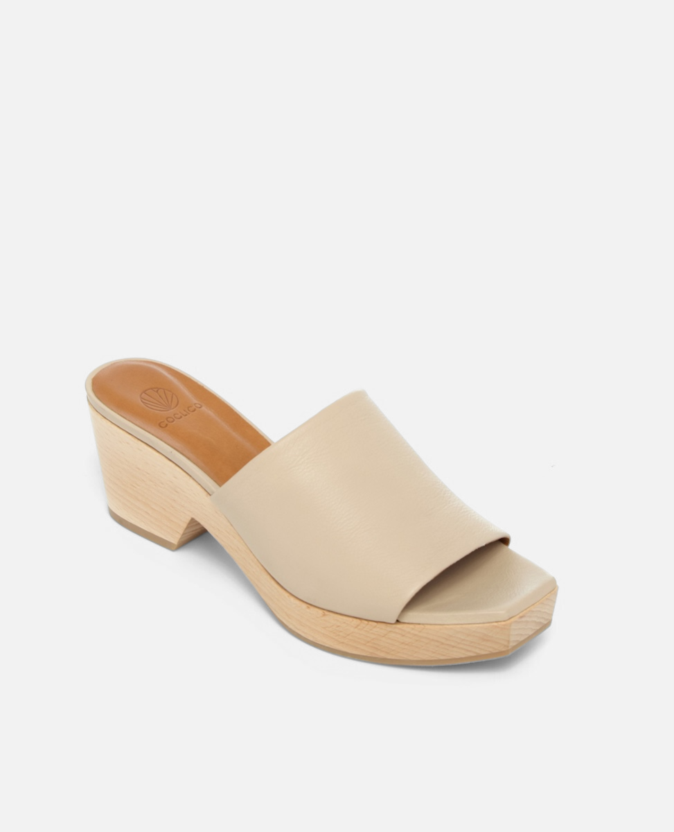 Beige sandal with wooden sole on a white background
