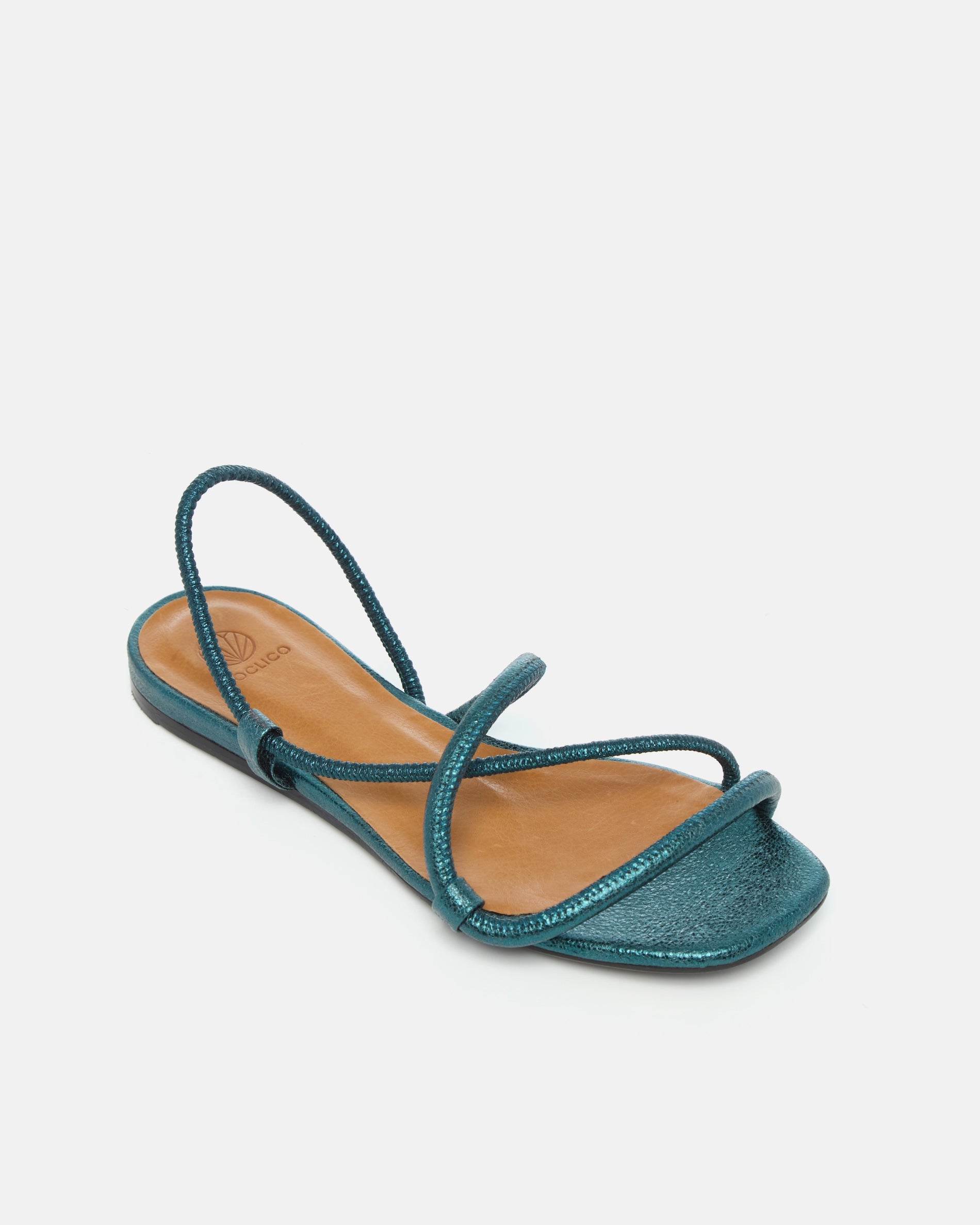 Angled view of a metallic blue crinkled leather flat sandal with slim padded straps, elasticated slingback, and a square toe on a grey background