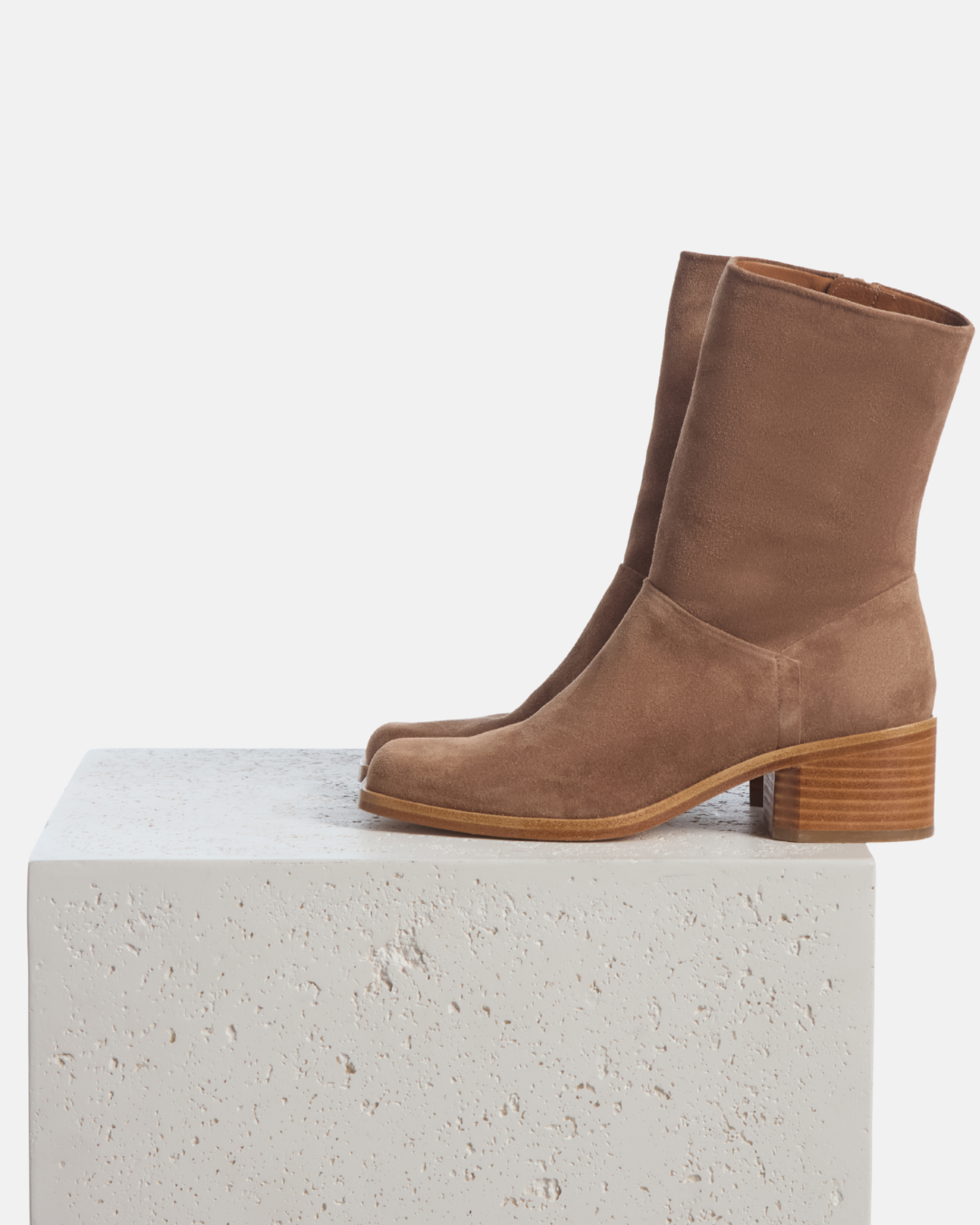 Coclico Air Boot in Dust split suede, ankle boots styled on a stone plinth