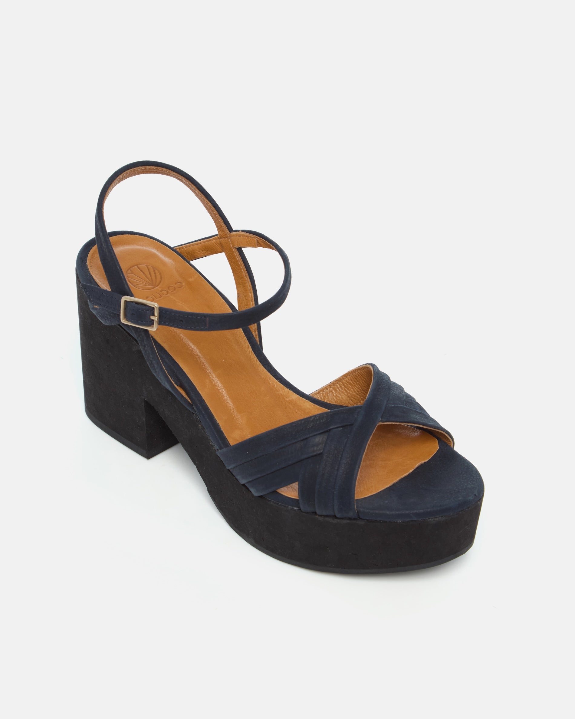 Angled view of a navy nubuck leather cork platform sandal with crisscross straps, adjustable ankle strap, and a lightweight cork sole.