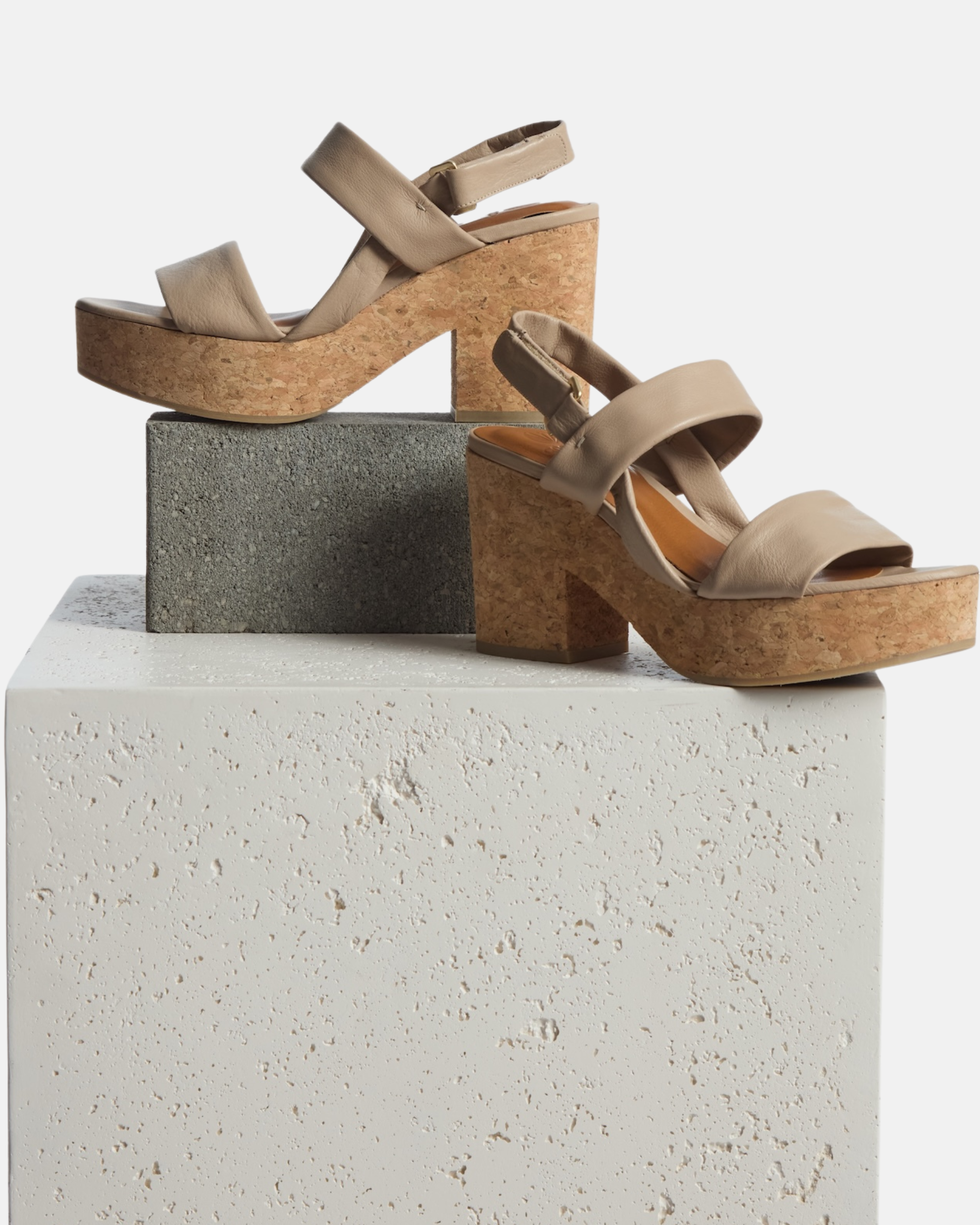 Shoe on plinth: grey leather platform sandal with tubular straps, adjustable velcro slingback, and cork platform sole