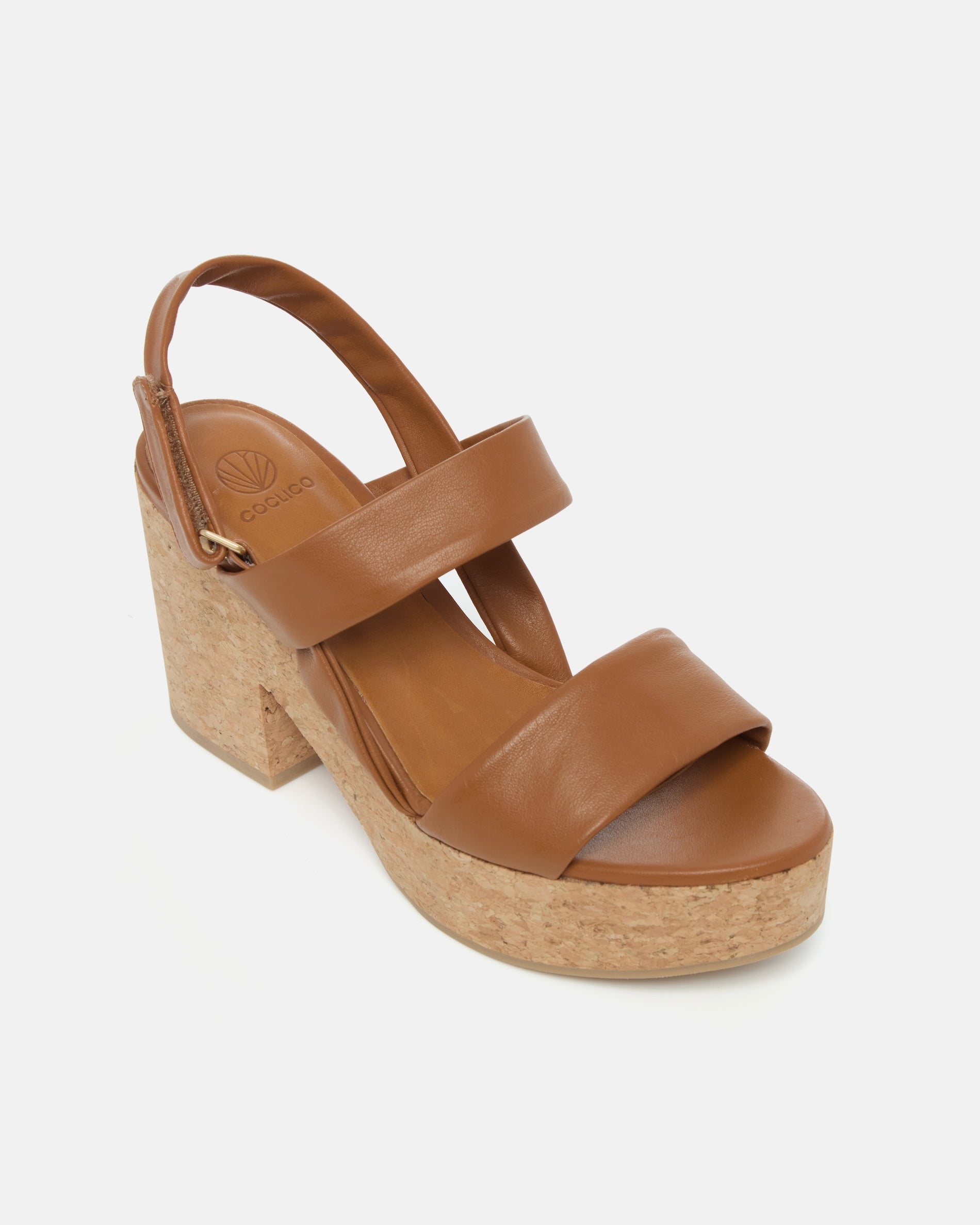 Angled view of a cuoio nubuck leather platform sandal with tubular straps, adjustable velcro slingback, and cork platform sole
