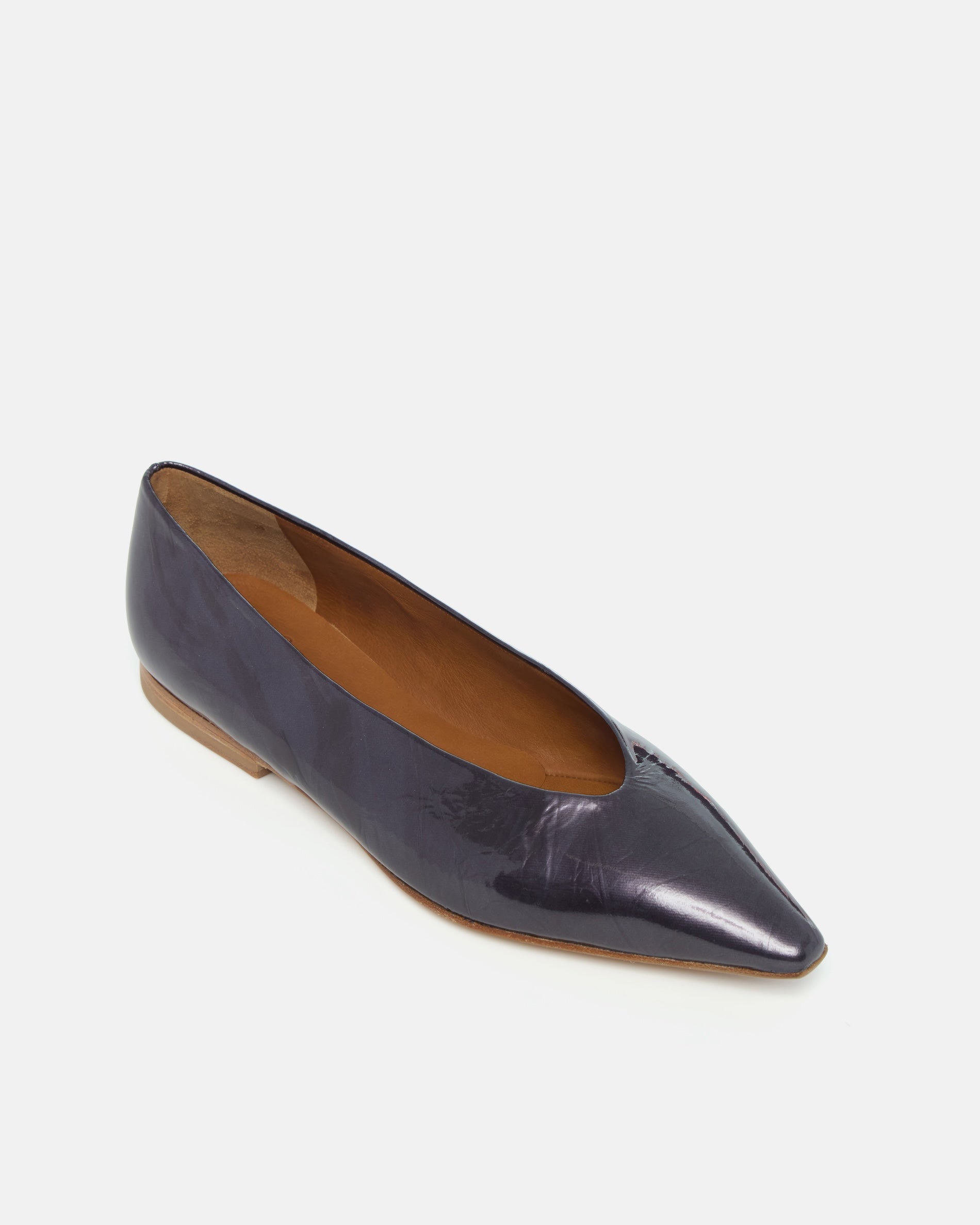 Angled view of a black pearl antiqued patent leather pointed-toe flat with clean lines and a flexible leather sole, on a white background.