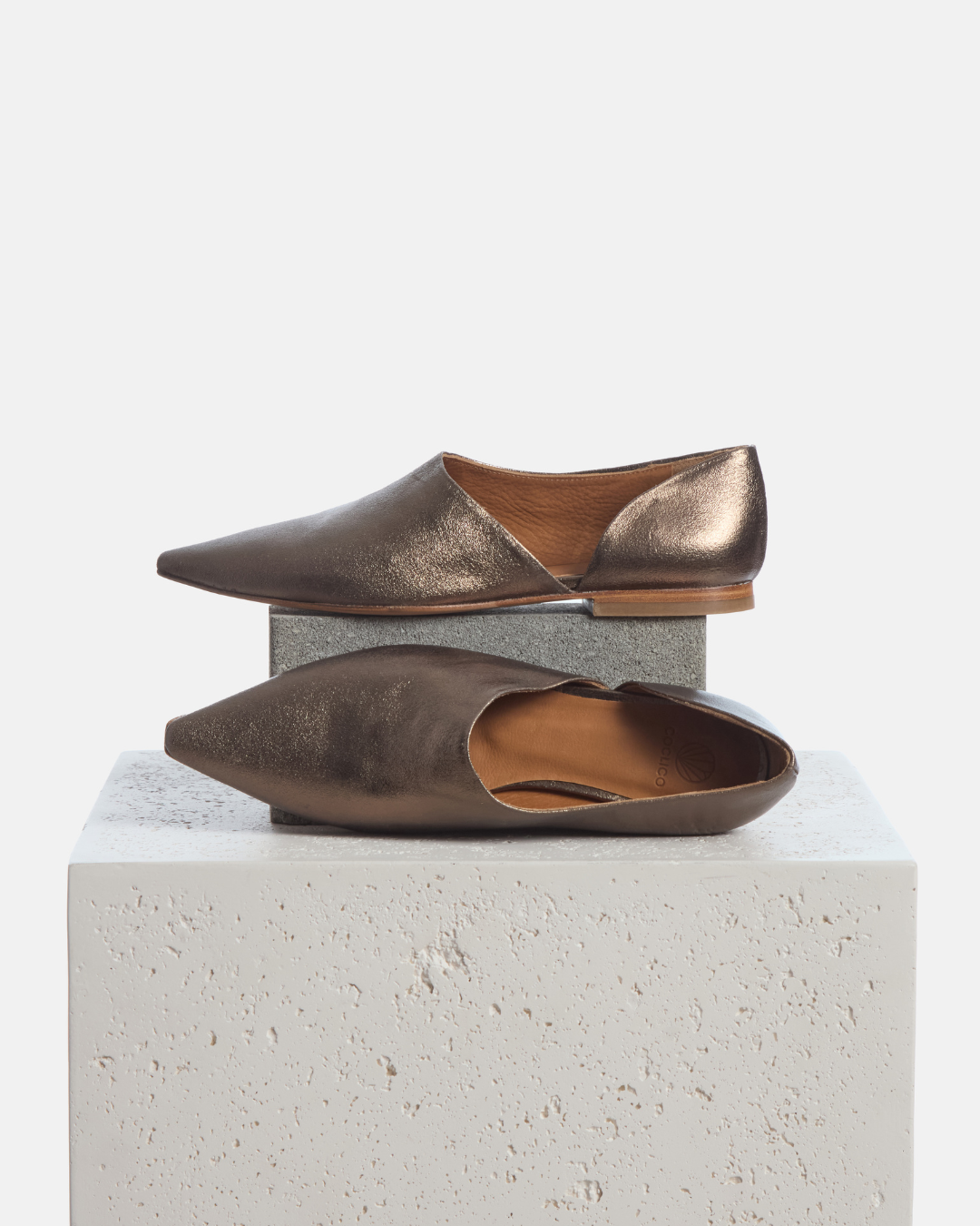 Coclico Coldplay Demi d'Orsay Flat in Bronze crinkled metallic, flats styled on a stone plinth