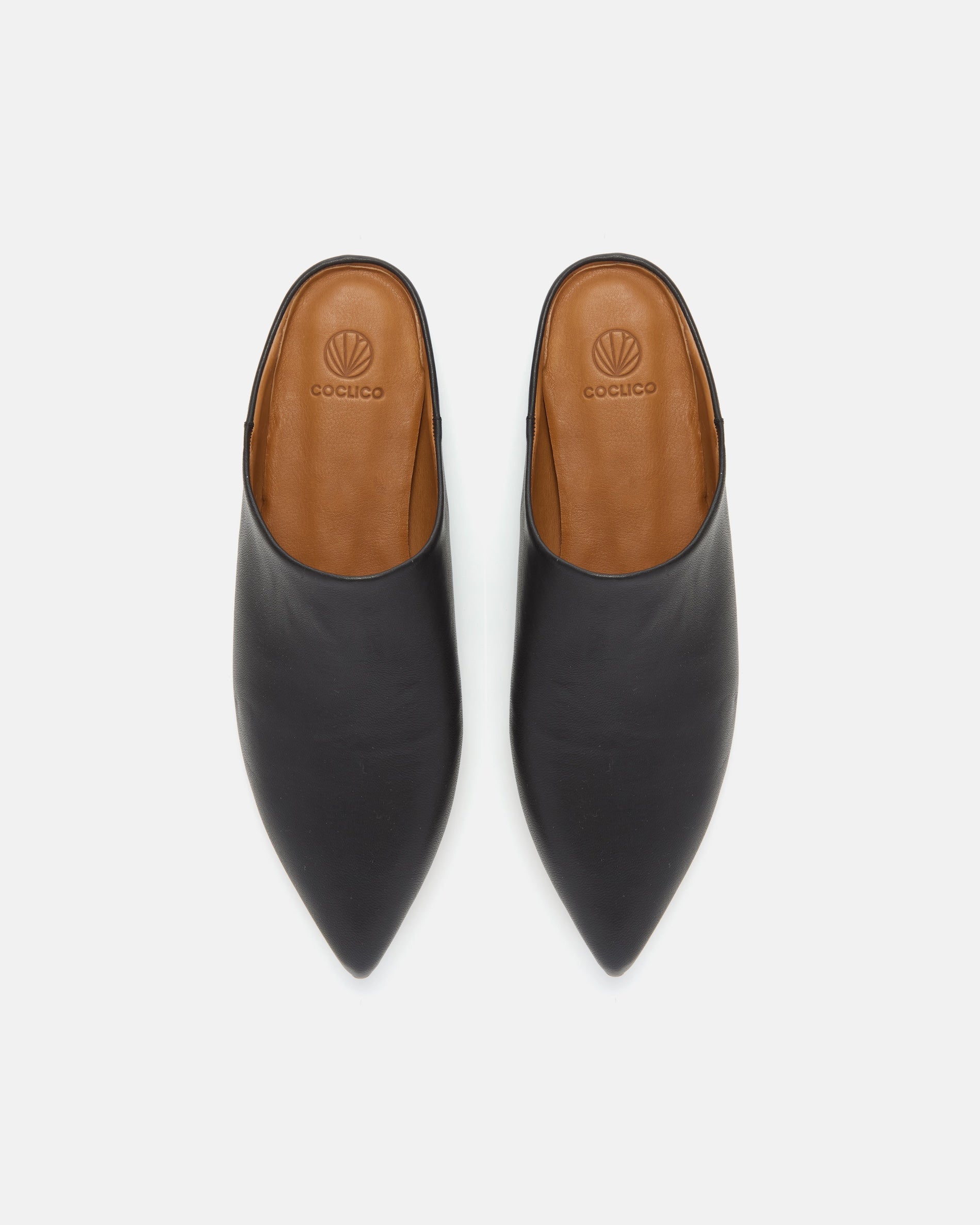 Top view of black pointed-toe leather mule with a slight built-in wedge and clean minimalist silhouette on a white background