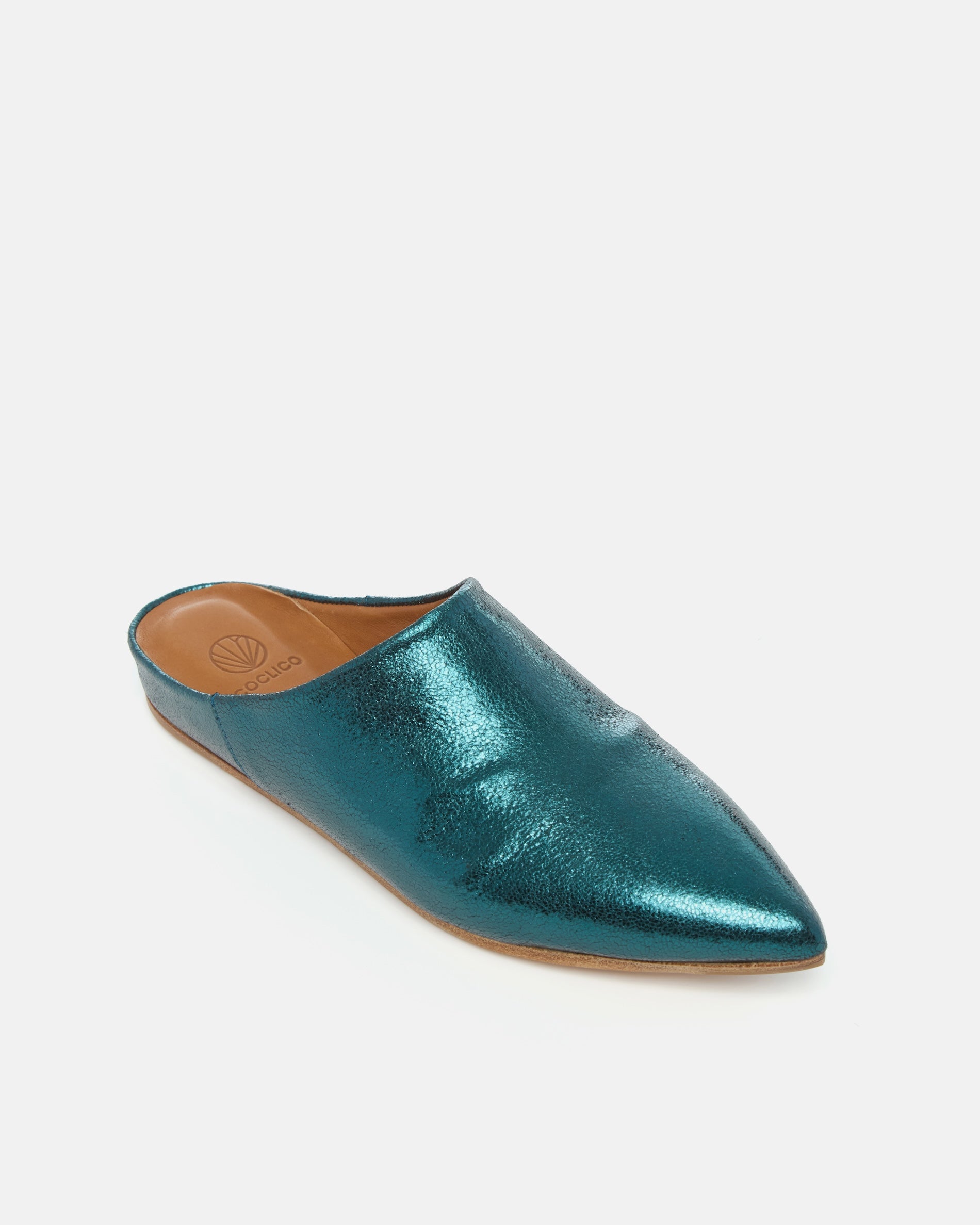 Angled view of a blue metallic pointed-toe leather mule with a slight built-in wedge and clean minimalist silhouette on a white background